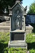 Starý náhrobek s figurálním reliéfem sv. Jana Nepomuckého.