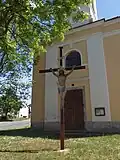 Kříž a vstup do kostela v západním průčelí