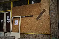 Zabedněná okna centra po útocích v únoru 2016