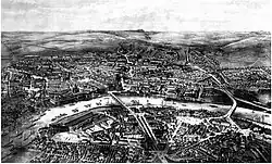 Černobílá reprodkce litografie, která zachycuje panoramatický pohled na město oblopující rameno řeky Labe