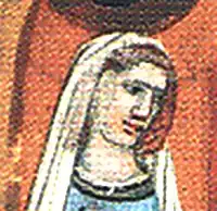 Na středověkém obrázku stojí hnědovlasá, do bílého šatu obléknutá žena s mírně skloněnou hlavou hledící směrem vpravo.