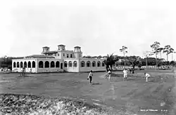 Golfers and caddies at Miami Country Club