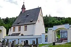 Vstupní partie hřbitova s branou a kostelem Všech svatých