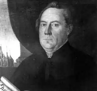 Lounský děkan a první čestný občan města Antonín Pankrác v pozadí s kostelem svatého Mikuláše