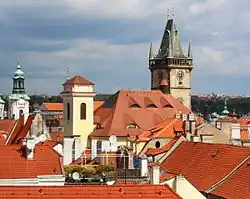 Kostel svatého Michaela archanděla (střecha a bílo-žlutá věž vlevo), podoba kostela z roku 2012.