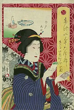 Dobový ukiyo-e zobrazuje krásnou žebny, jak si prohlíží Učidovu carte de visite
