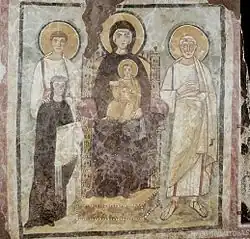 Felix a Adauctus vyobrazeni v bílém na fresce z roku 528 v Commodillské katakombě v Římě