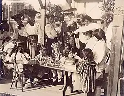 Model Playgrounds at the 1904 World's Fair. Children seated at a table playing with blocks. "Rosie of the Orient" third from right