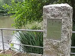 Pohled na žulový sloupek nad hladinou rybníka