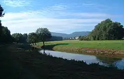 Hraniční tok Lužické Nisy u Hartau, v pozadí Lužické hory