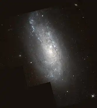 Spirální galaxie NGC 6207 na snímku z Hubbleova vesmírného dalekohledu. Autor: ESA/NASA.