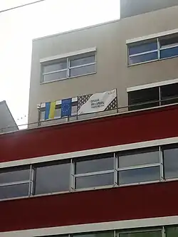 Zleva doprava vyvěšená ukrajinská vlajka, vlajka Evropské unie a banner s grafikou Pirátů a heslem Odvaha pro Evropu, Evropa pro tebe