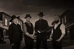 Kapela Poly Noir & The Holy Spirit Smugglers (2024) Zleva: Tomáš Šlápota, Jan Fic, Petr Pálenský, David Horák