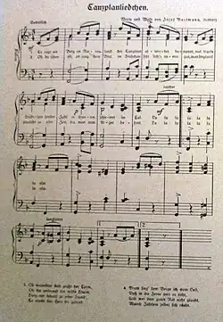 Ofocená stránka s notovým zápisem písně Tanzplanliedchen. Text je psaný švabachem, první dvě sloky jsou zapsané přímo pod linkami, třetí a čtvrtá sloka jsou uvedeny na spodní straně listu.