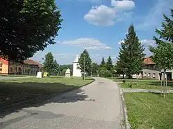 Náves se zvonicí a sochou piety