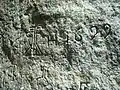 Detail skály s letopočty 1699 a 1888