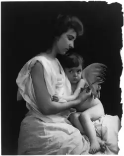 Woman holding scissors and winged child